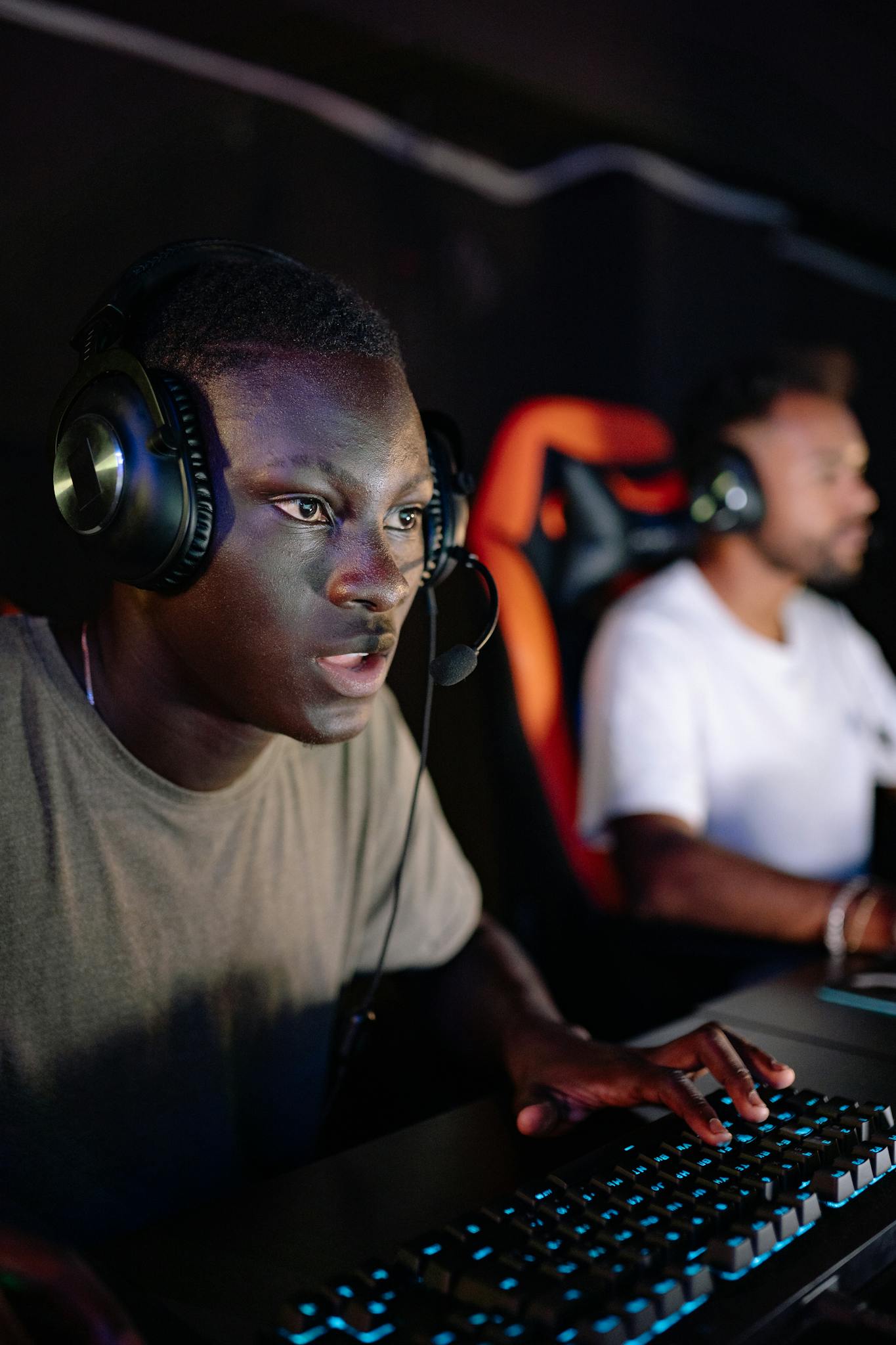 Two young men immersed in a competitive video gaming session.